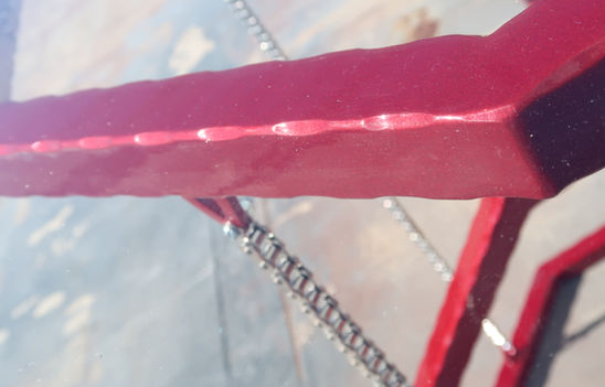 red powder coated steel frame detail on custom bar height table