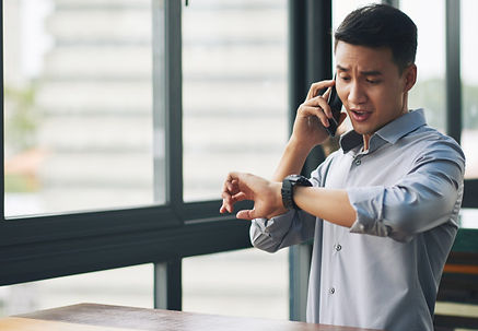 panicking-asian-man-talking-mobile-phone