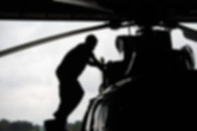 Aircraft mechanic, black and white , Male pilot checks the tail of helicopter before the flight.jp