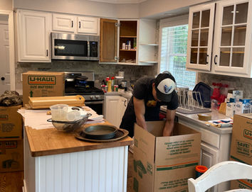 Mover packing dishes into boxes