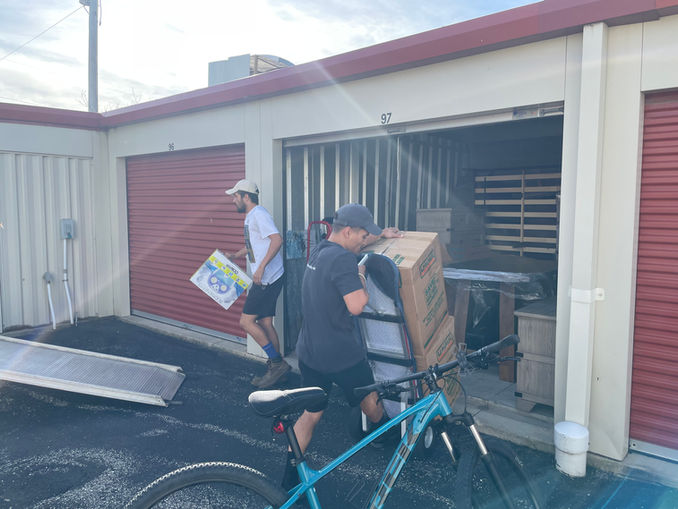 Movers moving items from storage into a boxtruck