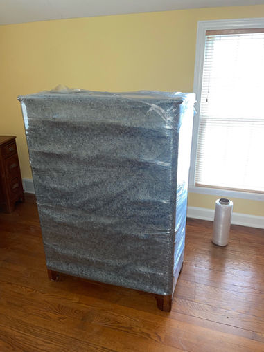 Dresser wrapped in Moving Blankets