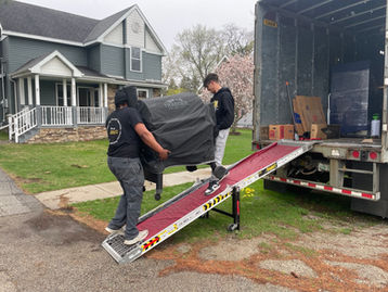 Movers Moving a Grill
