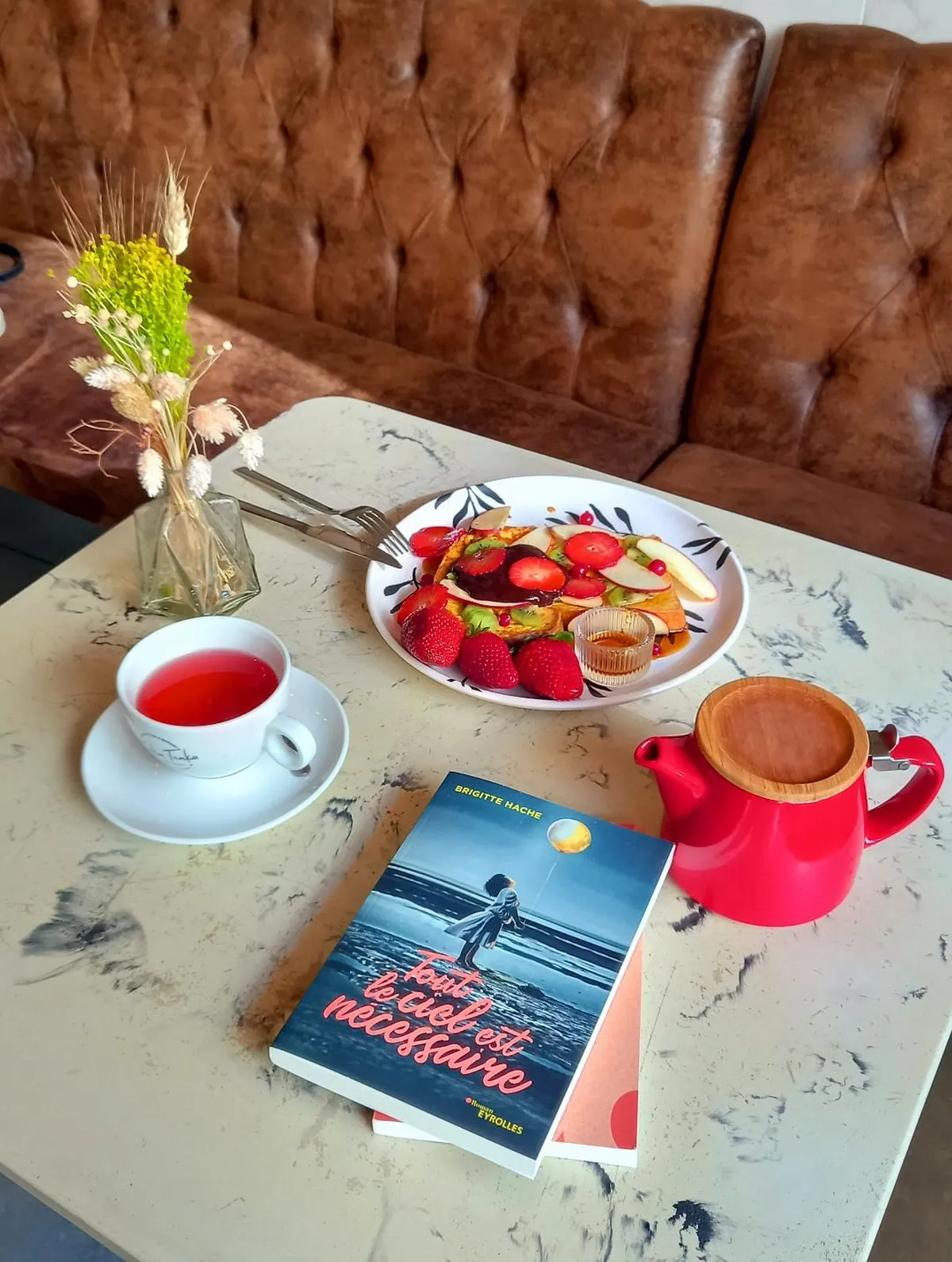 Le roman “Tout le ciel est nécessaire” de Brigitte Hache, publié chez Eyrolles posé sur la table d'un brunch