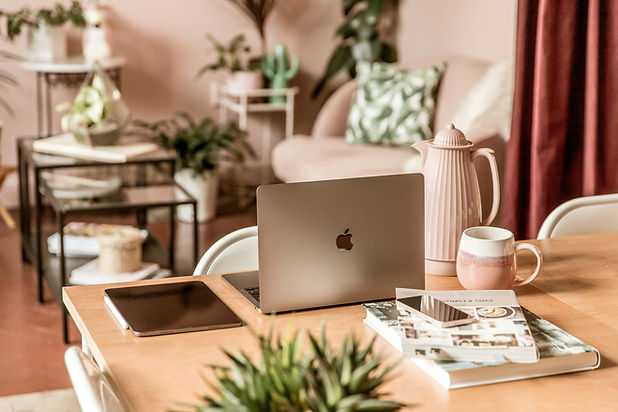 Tablet, notebook, and coffee arranged on a workspace