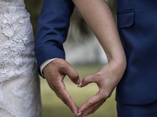 A bride and groom take a moment to hold hands on their wedding day at Kateri Weddings and Events