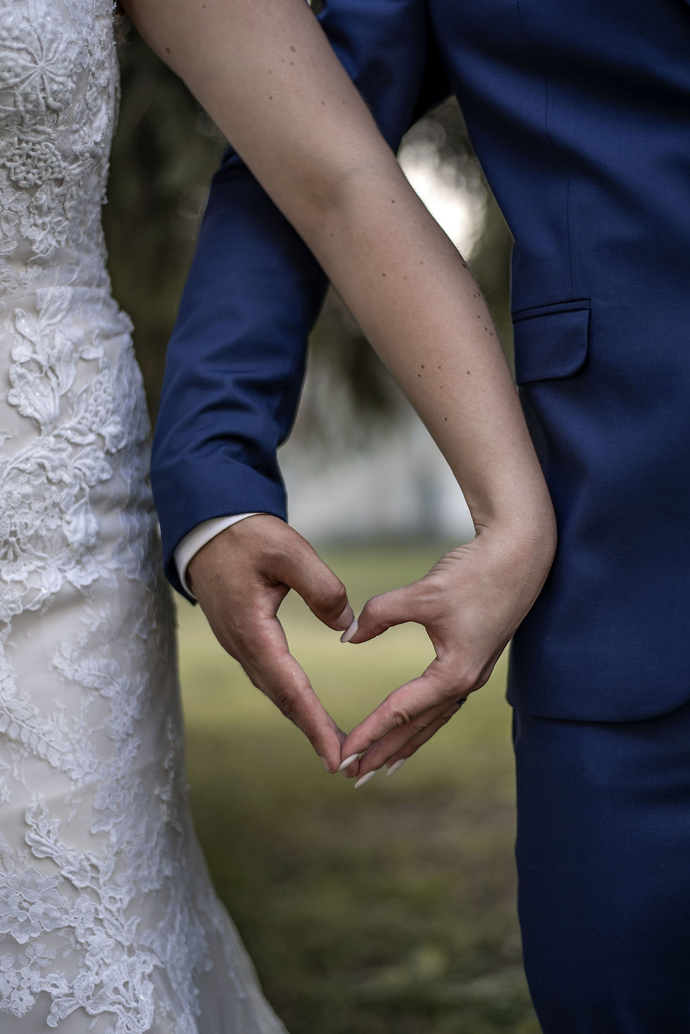A bride and groom take a moment to hold hands on their wedding day at Kateri Weddings and Events
