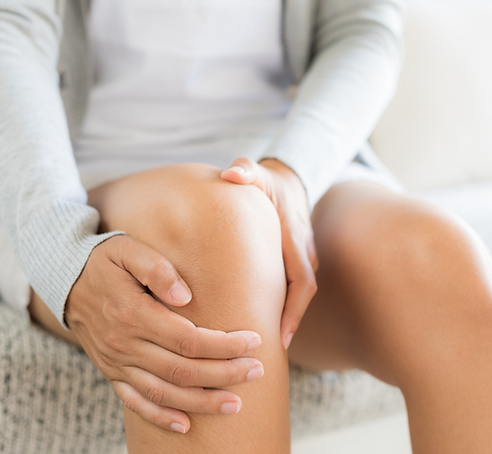 Women grabbing her knee in pain
