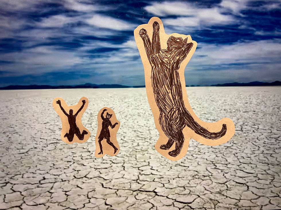 Giant cat sculpture with dancing people.