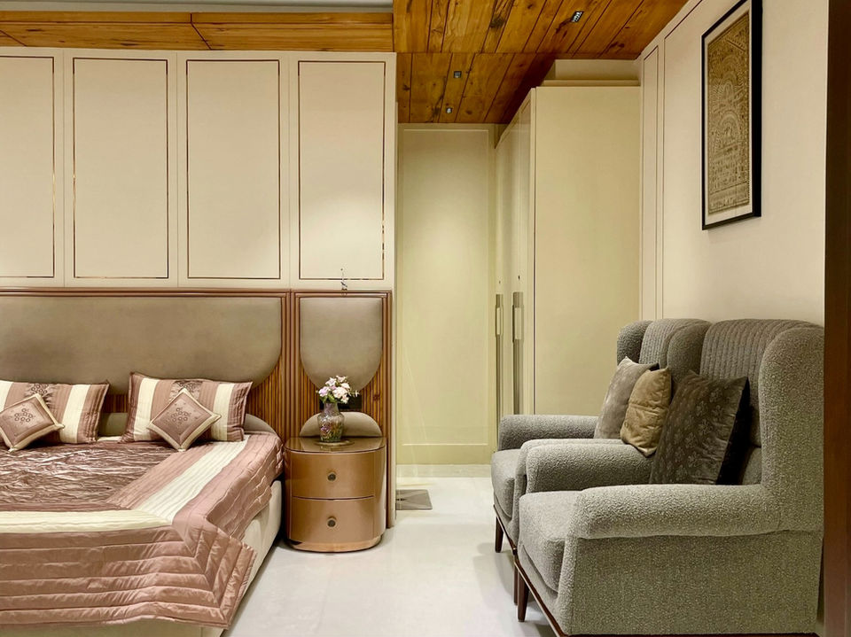 A serene master bedroom featuring a beautiful pinewood ceiling and golden accents. The room blends classic and modern styles, creating a warm and inviting atmosphere.