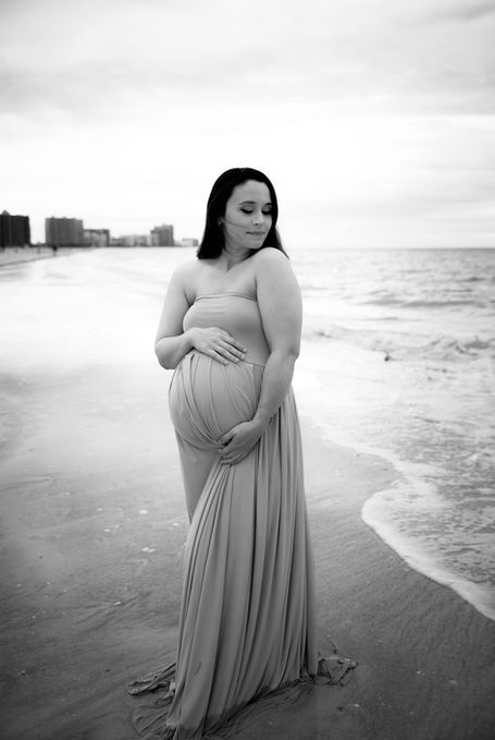 Black-and-white maternity photo showcasing the curves and beauty of motherhood.