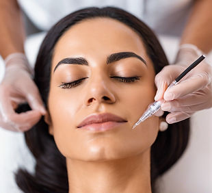 Shot of middle eastern woman getting a micro needling treatment.jpg