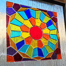 Three decorative Bullseye fused glass tiles for a window and front door of a house in Clerkenwell, London 
The brief for this project was for me to design three glass panels with a Moorish influence for the house owner to make during an intensive glass fusing weekend in my studio.
After learning how to cut glass and the techniques of fusing glass my client chose the colours, cut the pieces and arranged them on clear glass bases for firing.
After firing the glass it was delivered to the house and fitted to existing glass windows using a strong adhesive tape.