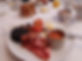A plate with full Yorkshire breakfast served in a bright and airy conservatory