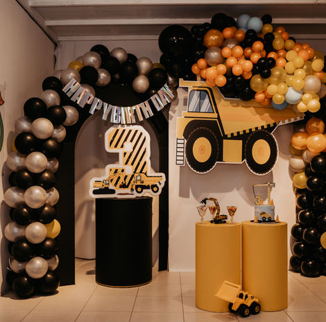 Custom yellow truck birthday decoration for kids in Dubai featuring themed backdrop, balloon styling, and party setup by Gogo Village.