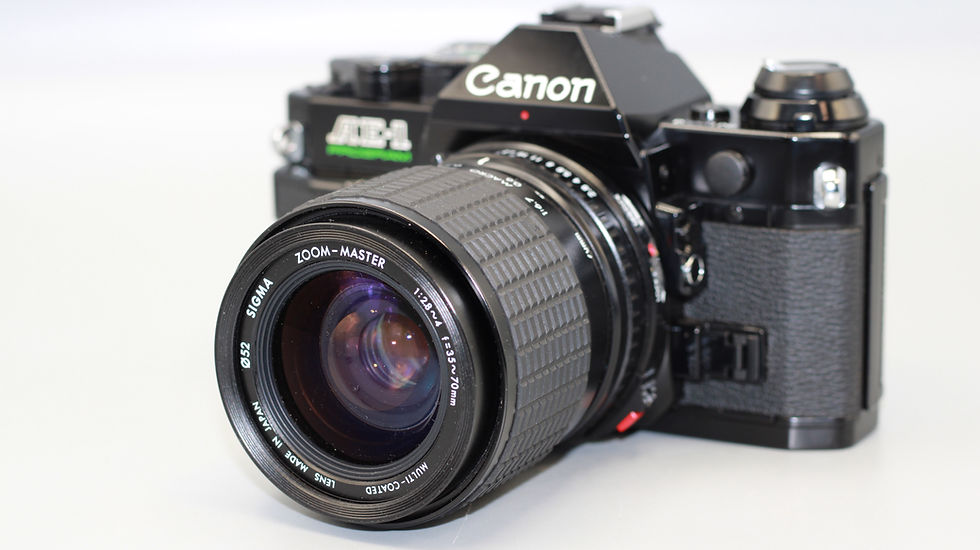Thumbnail: Canon AE-1 Program 35mm SLR Film Camera + Sigma 35-70mm f/2.8-4 Lens
