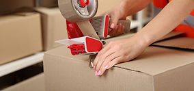 Person Taping Box at Warehouse