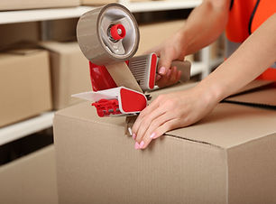 Person Taping Box at Warehouse