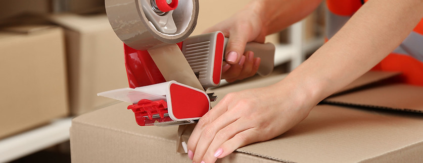 Person Taping Box at Warehouse