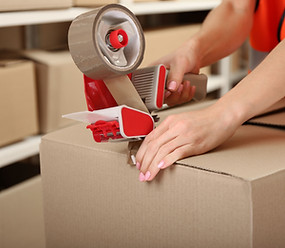 Person Taping Box at Warehouse