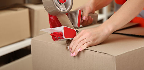Person Taping Box at Warehouse