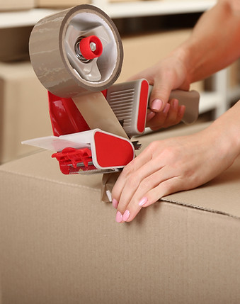 Person Taping Box at Warehouse