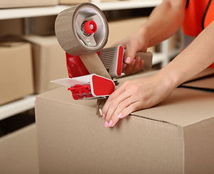 Person Taping Box at Warehouse