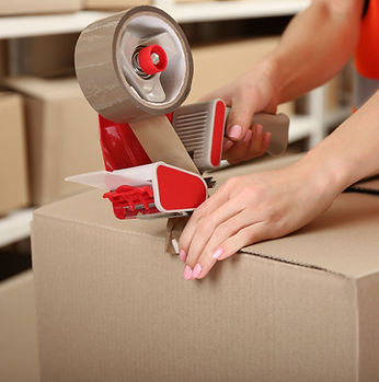 Person Taping Box at Warehouse