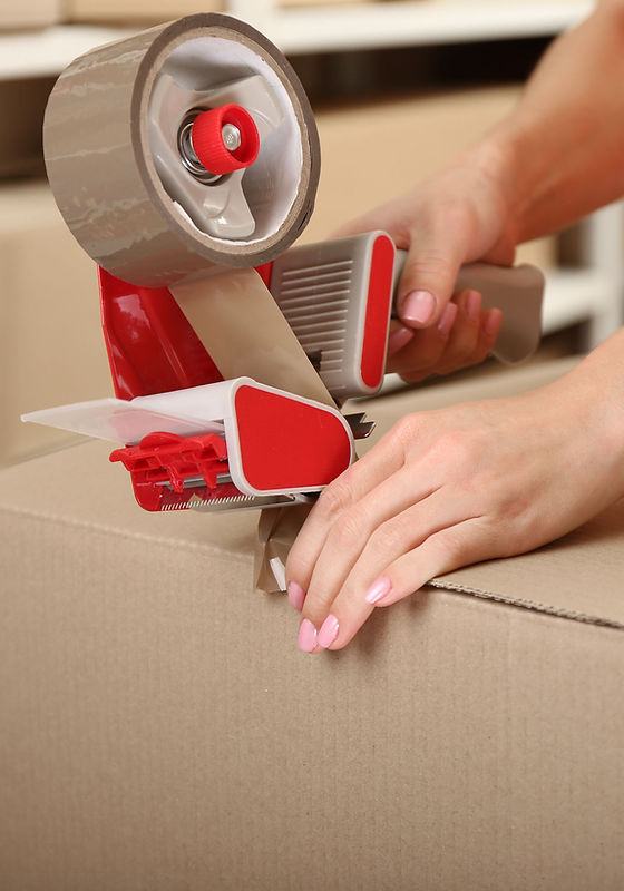 Person Taping Box at Warehouse