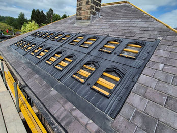 Roof under construction showing multiple vent openings and wooden battens