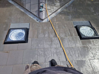 Tiled roof featuring two round roof vents installed