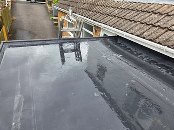 Flat roof installation showing clean seams and smooth felt finish