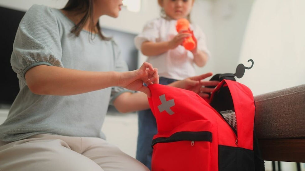 Parent preparing a red first aid kit