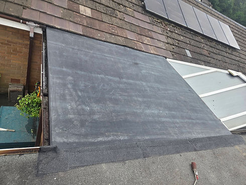 Newly laid felt flat roof extension attached to a residential house