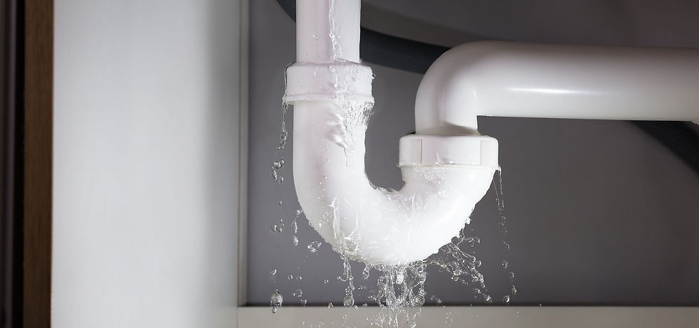 Water leaking heavily from plastic U-bend waste pipe under sink