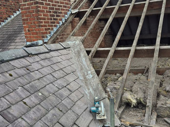Roof repair work in progress showing exposed timber battens