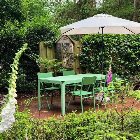 green table and chairs in a garden