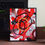 Thumbnail: Abstract red and black art with circles, framed, on a brick floor. Debbie Tracey Art.