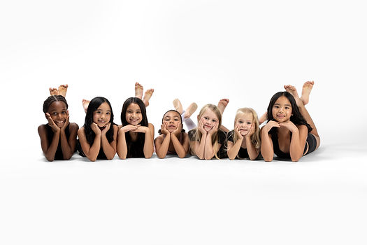 Young dancers posing with their hands under their chins