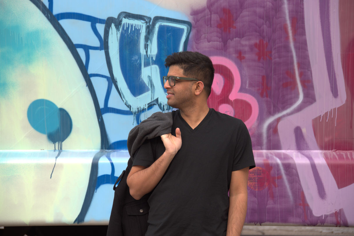 Glen Saldanha in front of grafitti wall