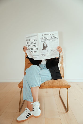 Brittany holding Grow and Glow newspaper concept