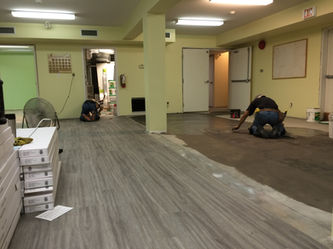 Flooring installation crew working on large construction project