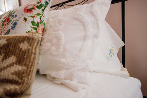 Soft decorative pillows arranged on a bed, adding warmth and texture to the room.