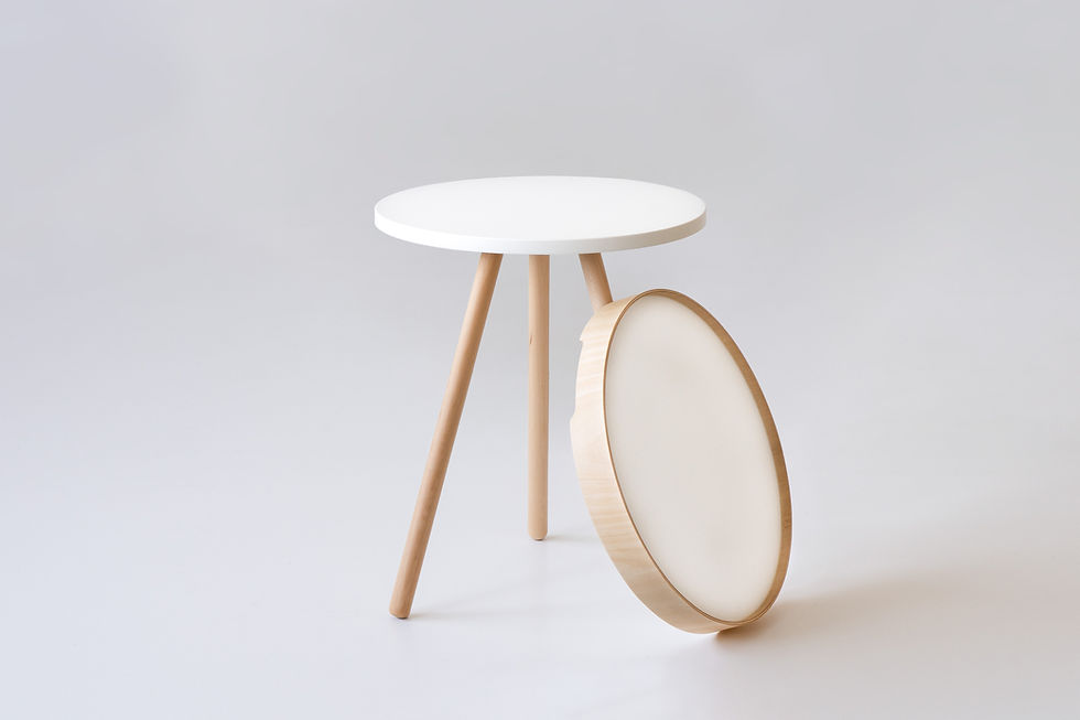 Thumbnail: A white tray table with three legs and a round wood-trimmed removeable table top that is displayed on the side as a tray