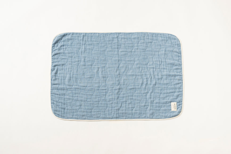 Thumbnail: A top view of a small, blue Japanese Blanked, cotton gauze blanket, patterned with a jacquard weave of white lines.