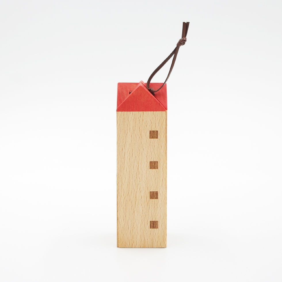 Thumbnail: A SunaoLab wooden House Trivet, made of four triangular prism parts that when standing upright create a tall house shape. The pointed roof is red and it is decorated with four burned in squares to appear like windows.