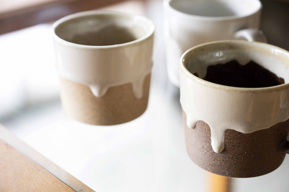 Thumbnail: Closeup of three Japanese ceramic Drop Mugs, each with a thick glossy white drip glaze.