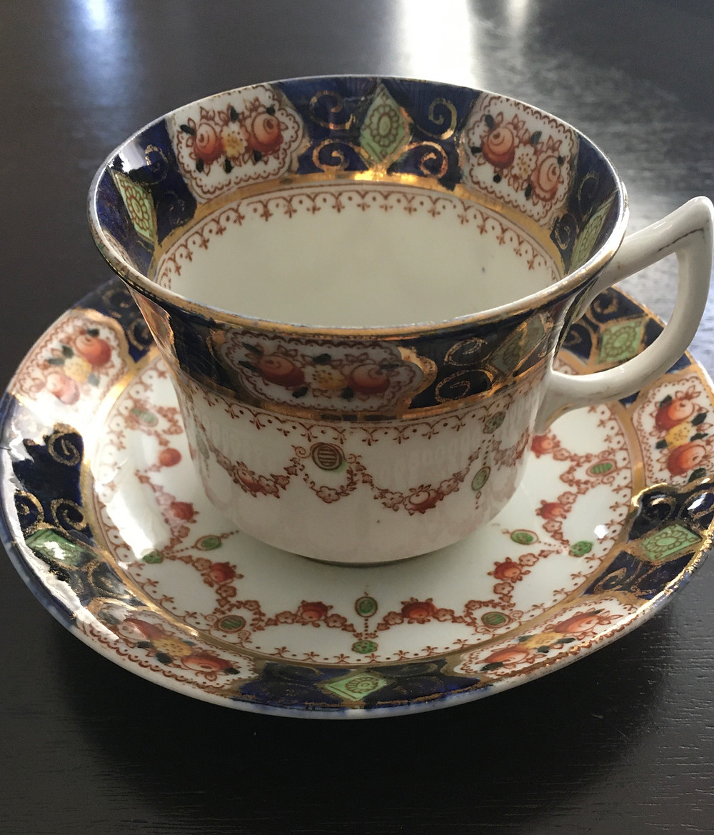 Blue, green, and gold Edwardian tea cup and saucer