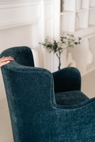 Canadian-made swivel chair with curved back and curved slope arms