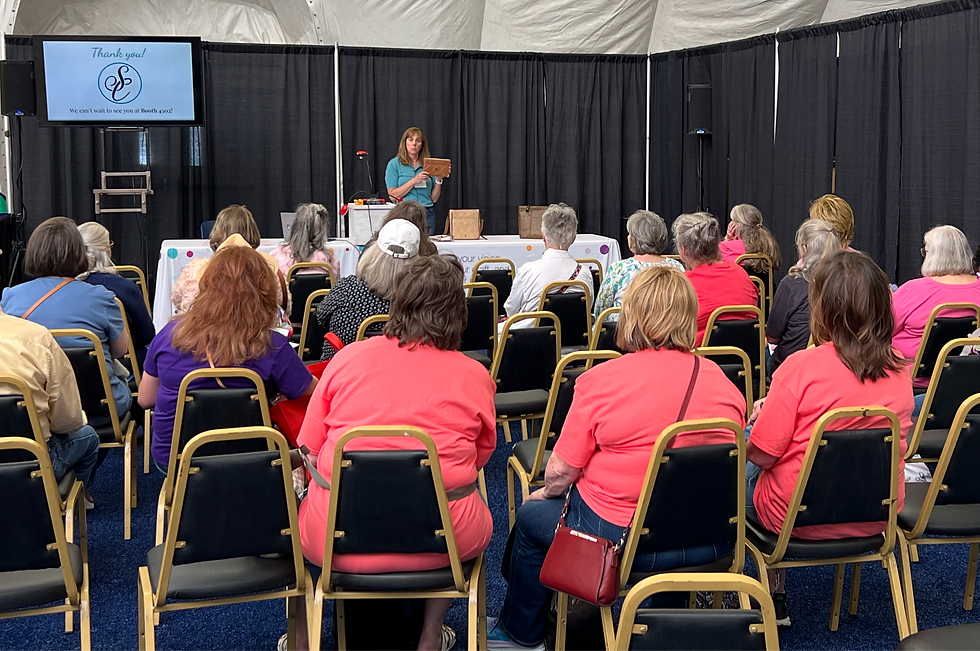 Chris Hall Murphy giving a presentation on the three Ts of leather for a group of attendees at QuiltWeek